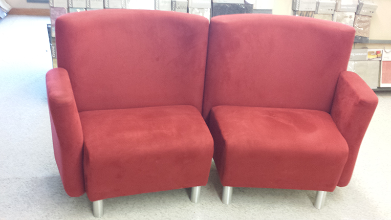 Two red upholstered chairs side by side